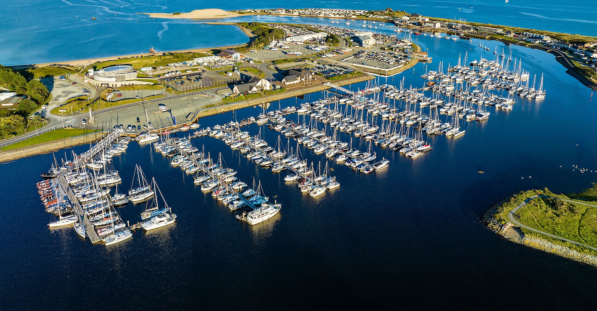 Aerial photo of the marina with blue skies and the sea